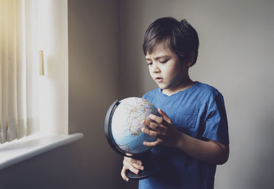 Boy looking at camera at home