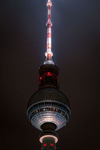 Low angle view of illuminated tower against sky at night