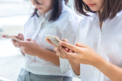 Midsection of woman using mobile phone