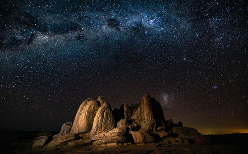 Majestic view of rock formation against star field at night