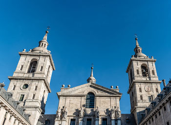 Low angle view of bell tower against blue sky