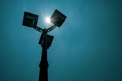 Low angle view of illuminated street light against sky