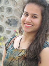 Close-up portrait of smiling young woman outdoors