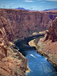 Boat traveling through the glen canyon dam and colorado river canyon in page, arizona.