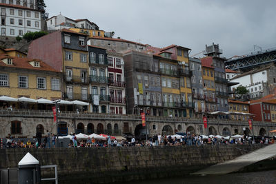 People on street against buildings in city