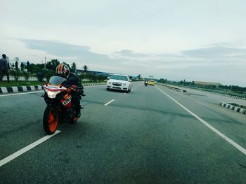 Cars on road against sky