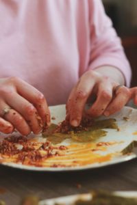 Close-up of hand holding pizza