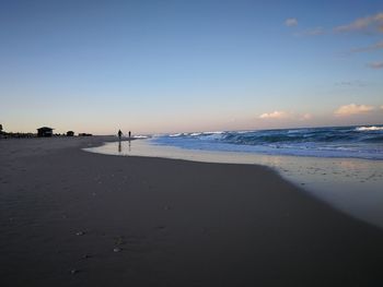 Scenic view of beach against clear sky