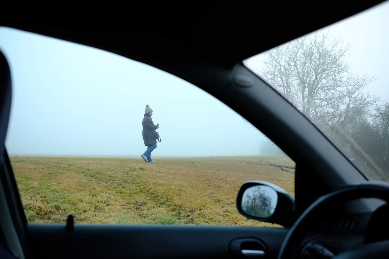 FULL LENGTH OF MAN SEEN THROUGH CAR WINDSHIELD