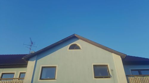 Low angle view of house against clear blue sky