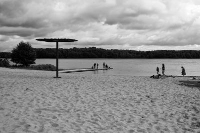 People on beach against sky