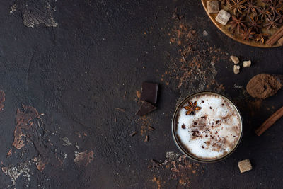 Homemade spicy hot chocolate with anise star, cinnamon sticks and bitter chocolate.