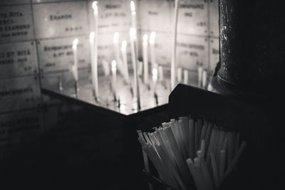 Close-up of lit candles in temple