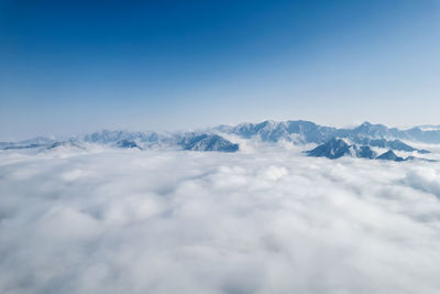 Low angle view of snowcapped mountains against sky