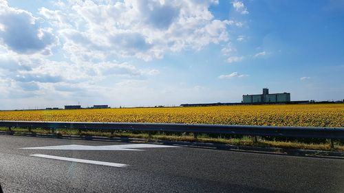 Road by landscape against sky