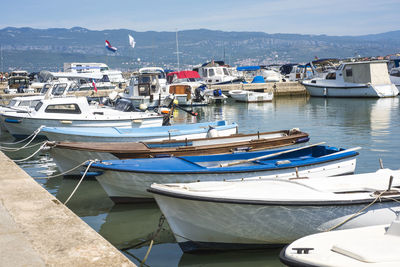 High angle view of sailboats moored at harbor