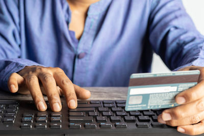 Midsection of man using laptop