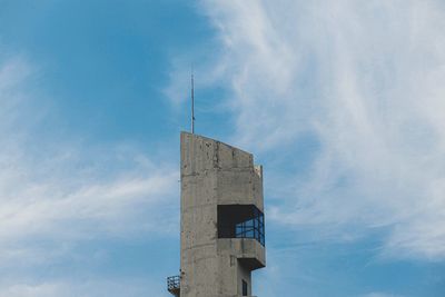 Low angle view of cross tower against sky