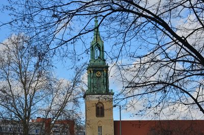 Low angle view of clock tower and building against sky