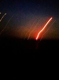 Light trails against sky at night