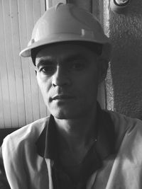 Portrait of manual worker wearing hardhat at construction site