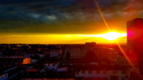 Silhouette cityscape against sky during sunset