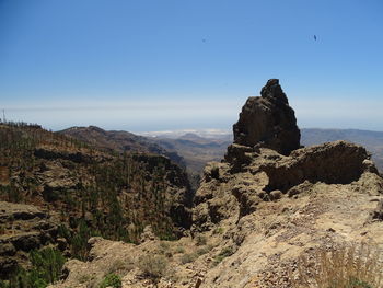 Rock formations on landscape against sky