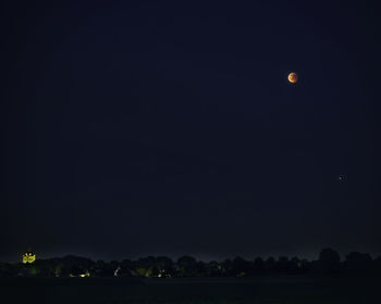 Scenic view of moon against clear sky at night