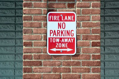 Close-up of sign on brick wall