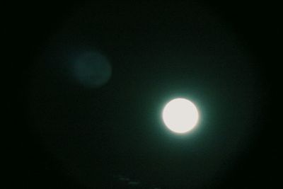 Low angle view of moon against sky at night