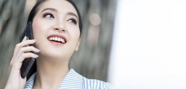 Portrait of a smiling young woman looking away