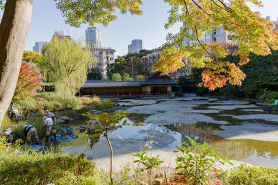 Scenic view of lake by buildings against sky