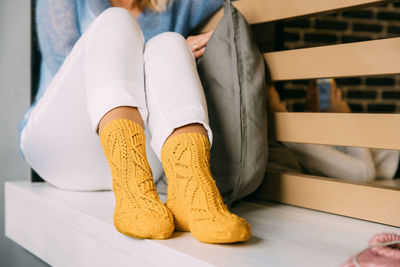 Low section of woman sitting on floor