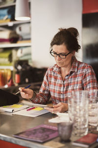 Woman sitting on table