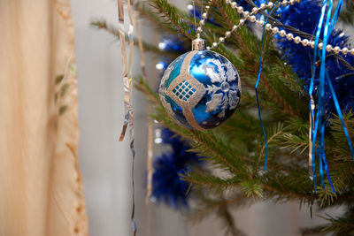 Close-up of christmas decorations hanging on tree