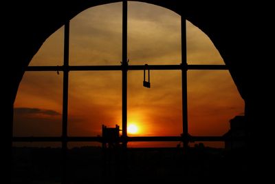 Scenic view of silhouette bridge against sky during sunset