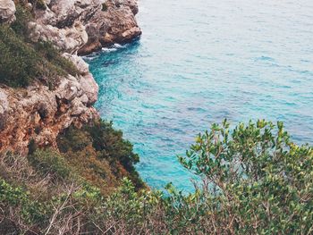 High angle view of rocks on sea