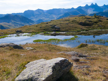 Scenic view of lake and mountains against sky