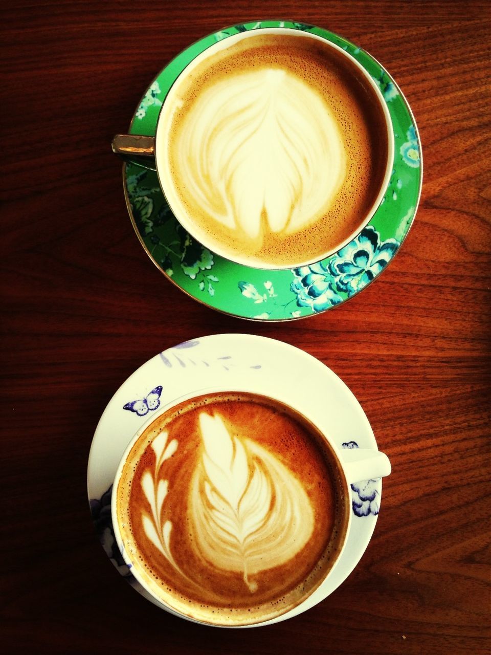 coffee cup, drink, froth art, refreshment, saucer, food and drink, cappuccino, frothy drink, coffee - drink, table, indoors, freshness, coffee, latte, still life, creativity, heart shape, art, cup, high angle view