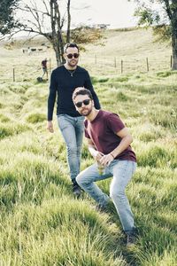 Full length of couple on field