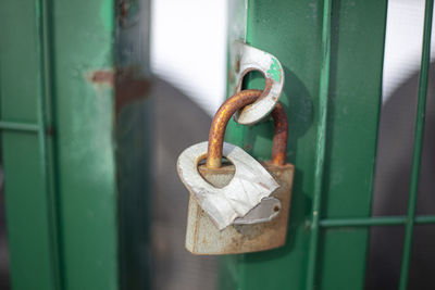 The castle hangs on the gate on the street. closed door. private property protection. 