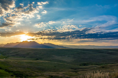 Scenic view of field against sky during sunset