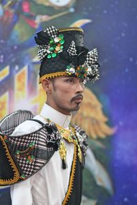 Man in traditional clothing looking away outdoors