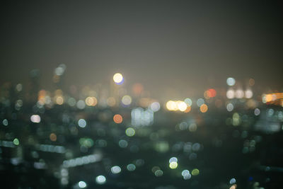 Defocused image of illuminated city at night