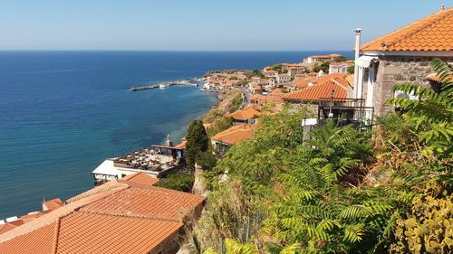 High angle view of townscape by sea against sky