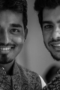 Close-up portrait of smiling friends in traditional clothing