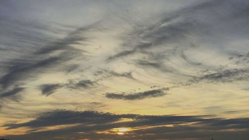 Low angle view of cloudy sky at sunset