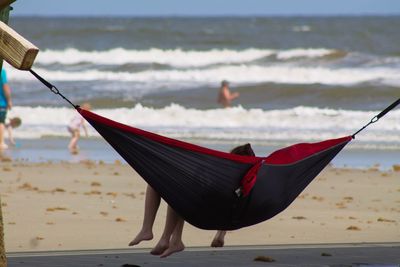 Rear view of man on beach against sky