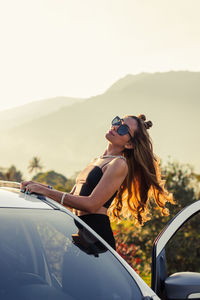 Girl on top of car