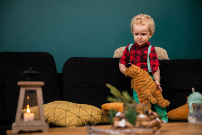 Portrait of boy playing with toys while sitting on table